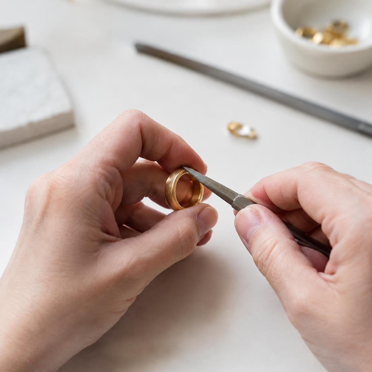 Karoli atelier — hands finishing a piece